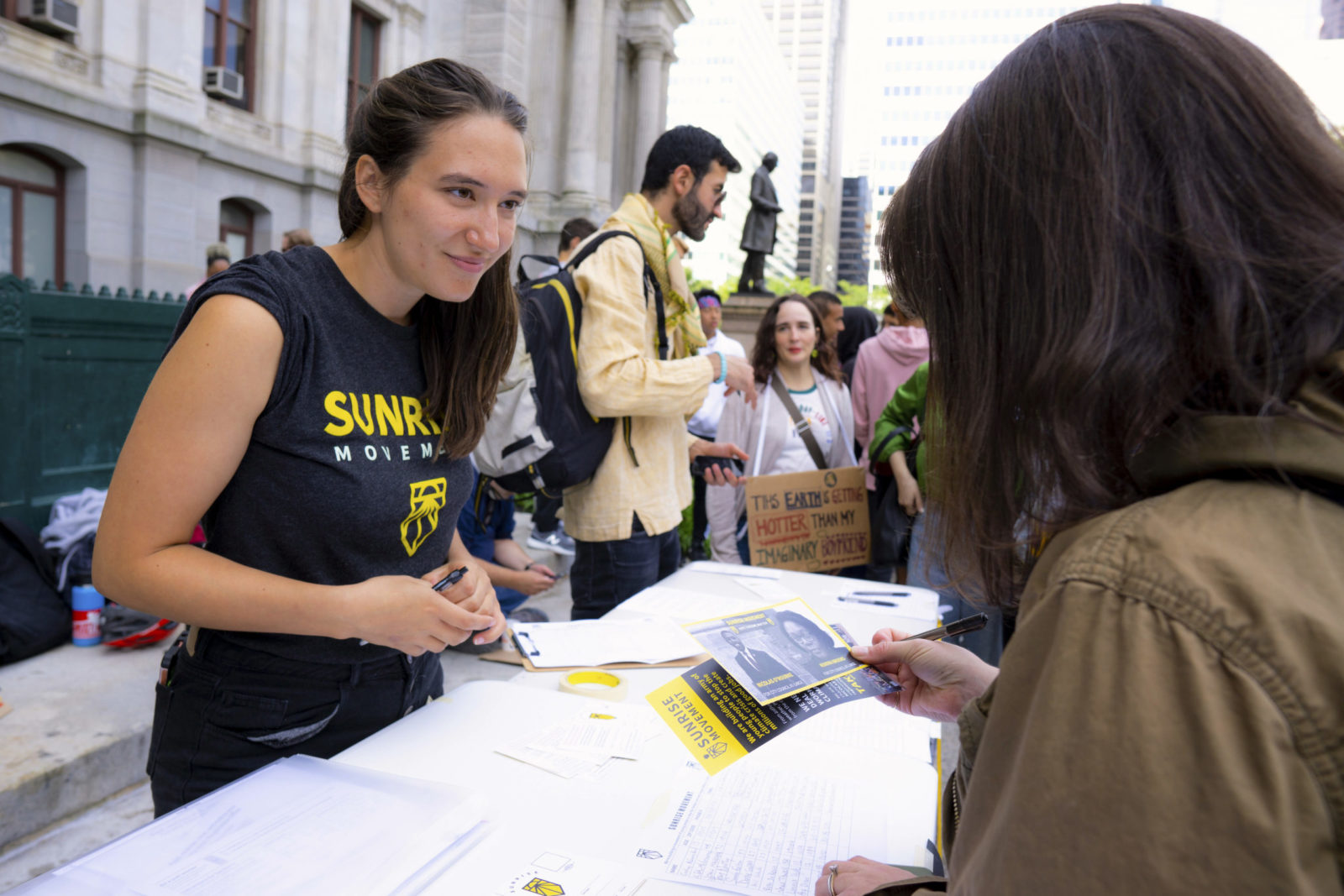 A Sunrise volunteer asking people to sign up for phone banking.