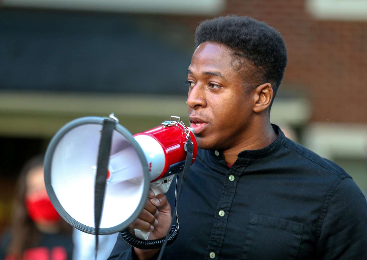 A Sunrise activist speaks into a megaphone. 