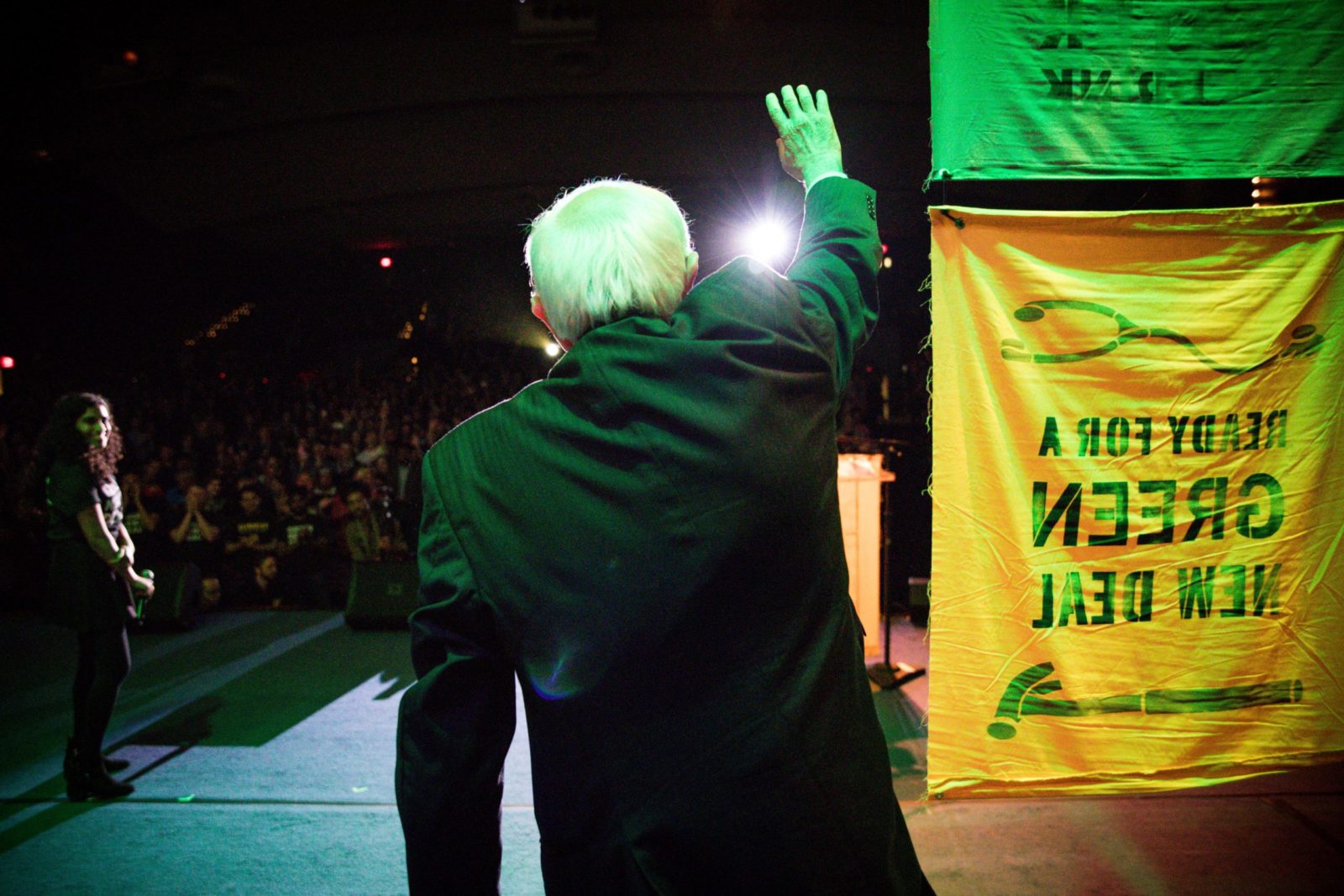 Bernie Sanders facing away from us as he enters the stage at the GND Tour