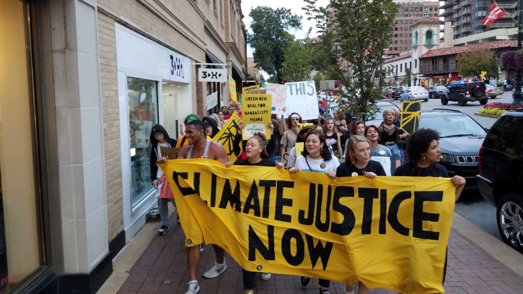 Gli attivisti portano uno striscione "Climate Justice Now" durante lo sciopero per il clima del settembre 2019.