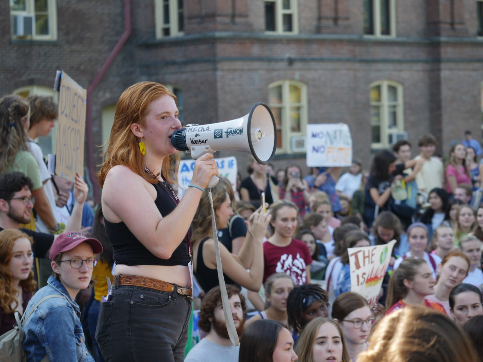 A Sunrise organizer speaks into a megaphone to a crowd during the September 2019 Climate Strike.