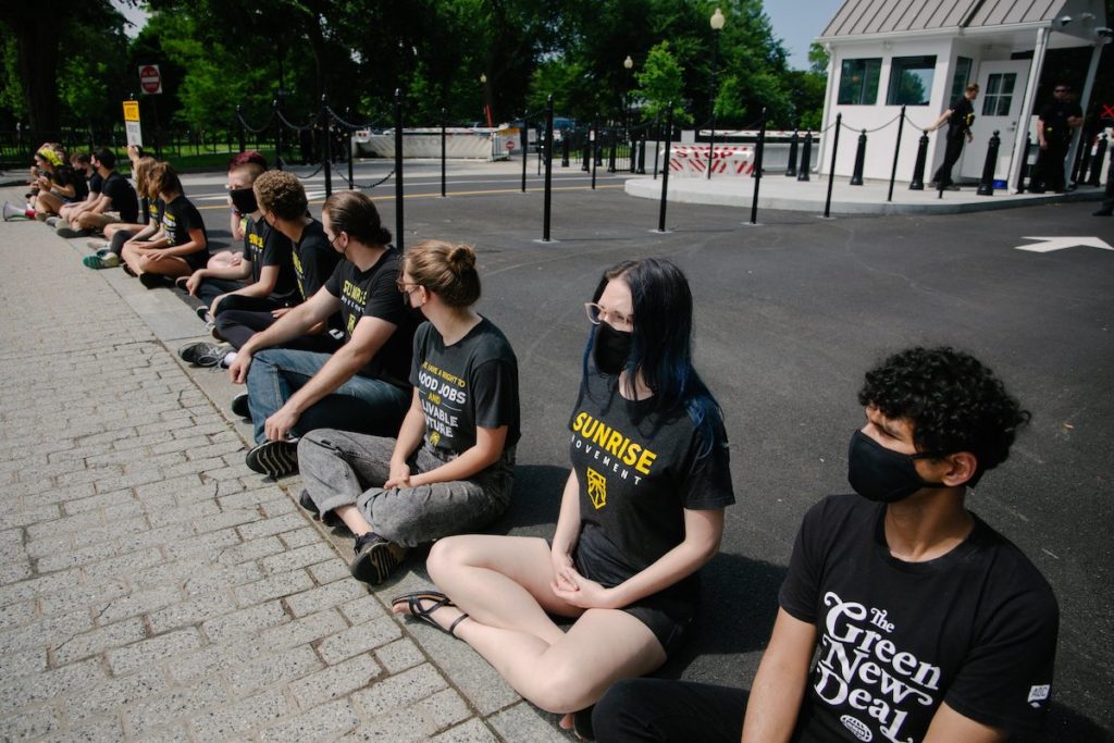 Sunrise protesters outside the White House fight for the CCC